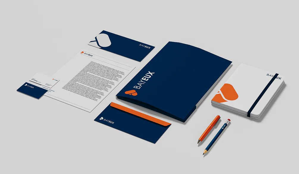 The Bayeux stationery set: navy folder, letterhead, business cards, envelope and a branded notebook