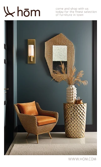 Brand card: a rattan armchair and a gold mirror against a slate wall