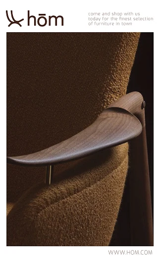 Brand card: a walnut chair arm against brown upholstery