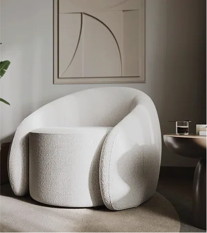 A white bouclé armchair beneath line art