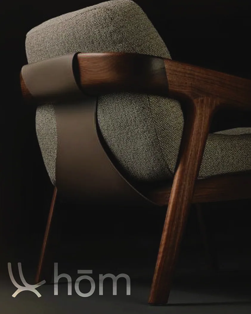 A walnut lounge chair on black with the hōm mark