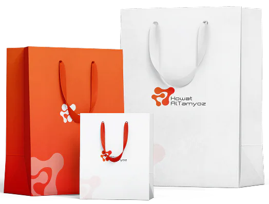 Three Howat Al Tamyoz shopping bags, one orange and two white