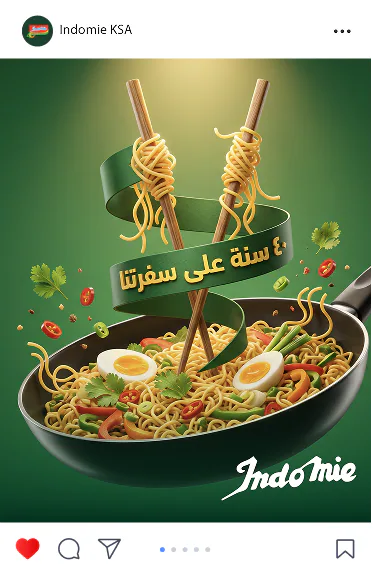 Indomie post: chopsticks lifting noodles from a wok under 40 years on our table in Arabic