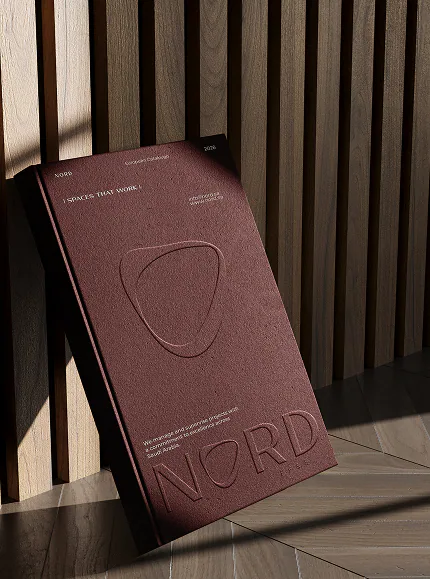 The company profile as an embossed oxblood cover leaning against timber