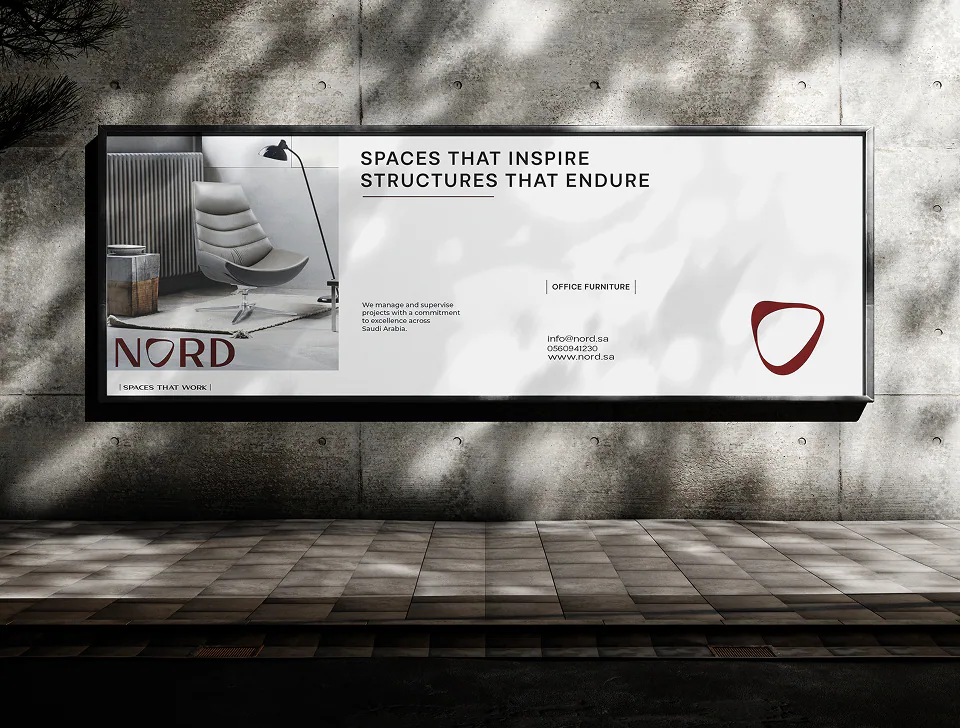 A street billboard: Spaces That Inspire, Structures That Endure, over an office chair