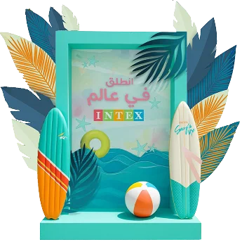 A 3D INTEX stand: a teal frame reading انطلق في عالم INTEX between surfboards, palm leaves and a beach ball