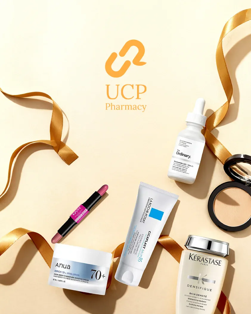 The UCP Pharmacy mark over a cream set with gold ribbon and a spread of skincare and beauty products