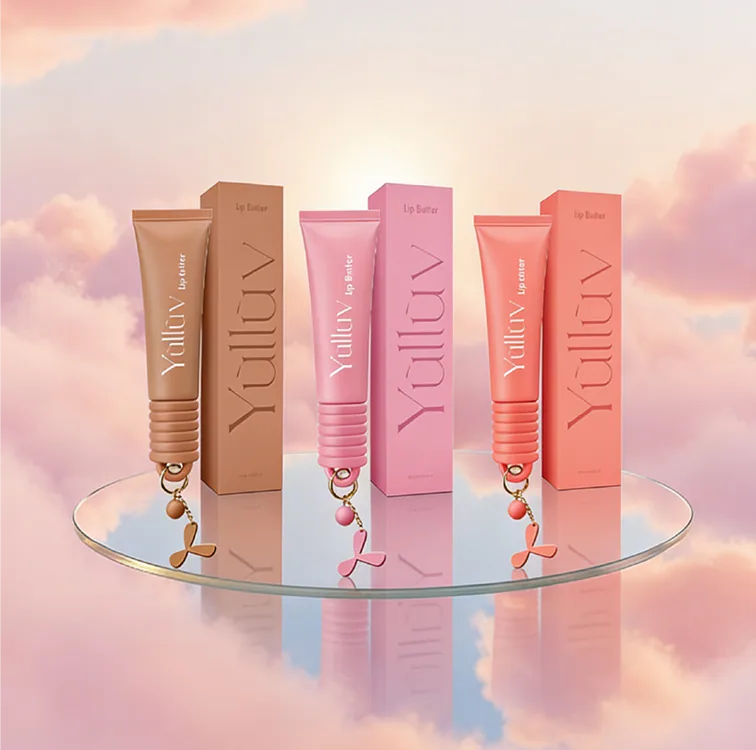 Three Yulluv lip butter tubes displayed among pink clouds